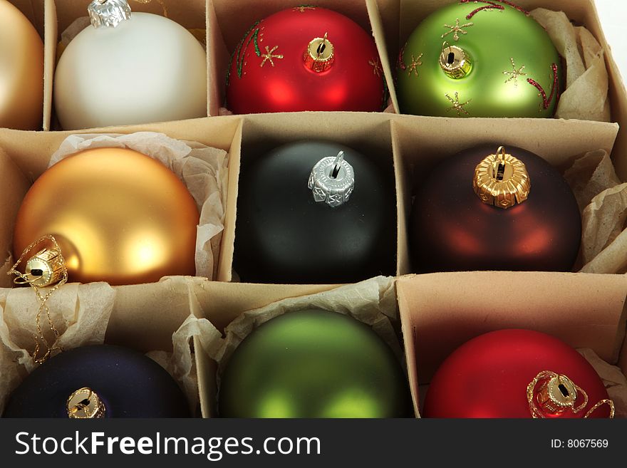 A group of christmas balls in a paper box, multiple colors. A group of christmas balls in a paper box, multiple colors