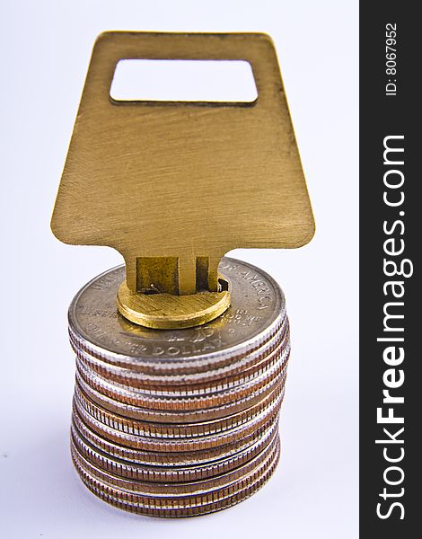 Stack of quarters with a lock and key. Stack of quarters with a lock and key.