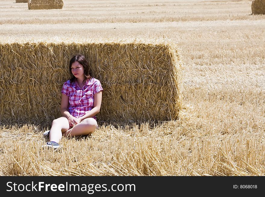 Young woman in haystack