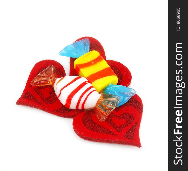 Three red hearts made of cloth and sweets isolated on a white background