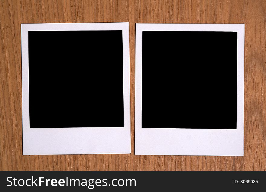 Two empty old photos on wooden background. Two empty old photos on wooden background
