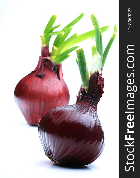 2 red onions on white background