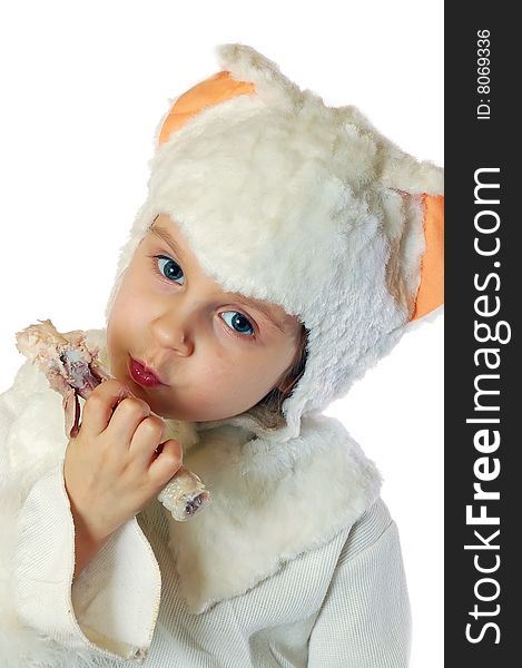 Child dressed as a kitten eating chicken. Child dressed as a kitten eating chicken