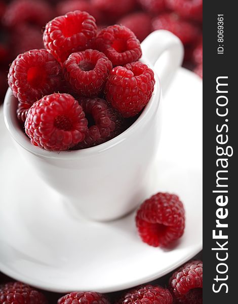 Raspberries in white cup , close up