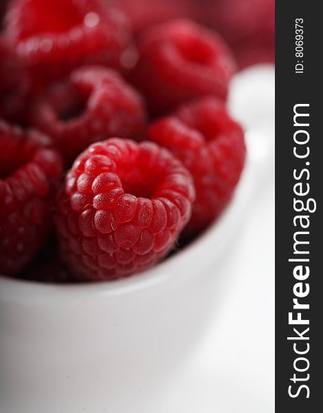 Raspberries in white cup, close up. Raspberries in white cup, close up