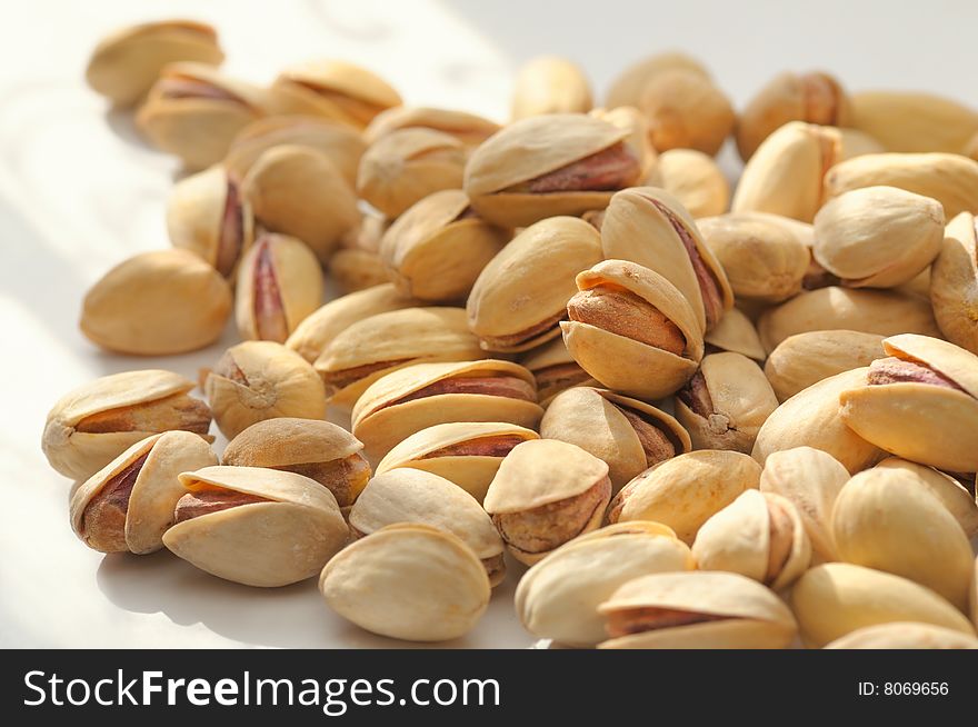 Handful of pistachios have been photographed with small DOF. Handful of pistachios have been photographed with small DOF.