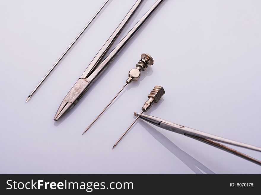 Surgical tools on a light blue background