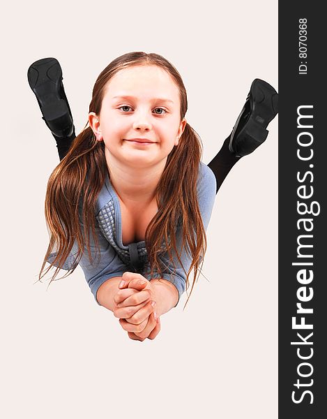 An little girl lying on her stomach on the floor of the studio and smiling
in the camera. An little girl lying on her stomach on the floor of the studio and smiling
in the camera.