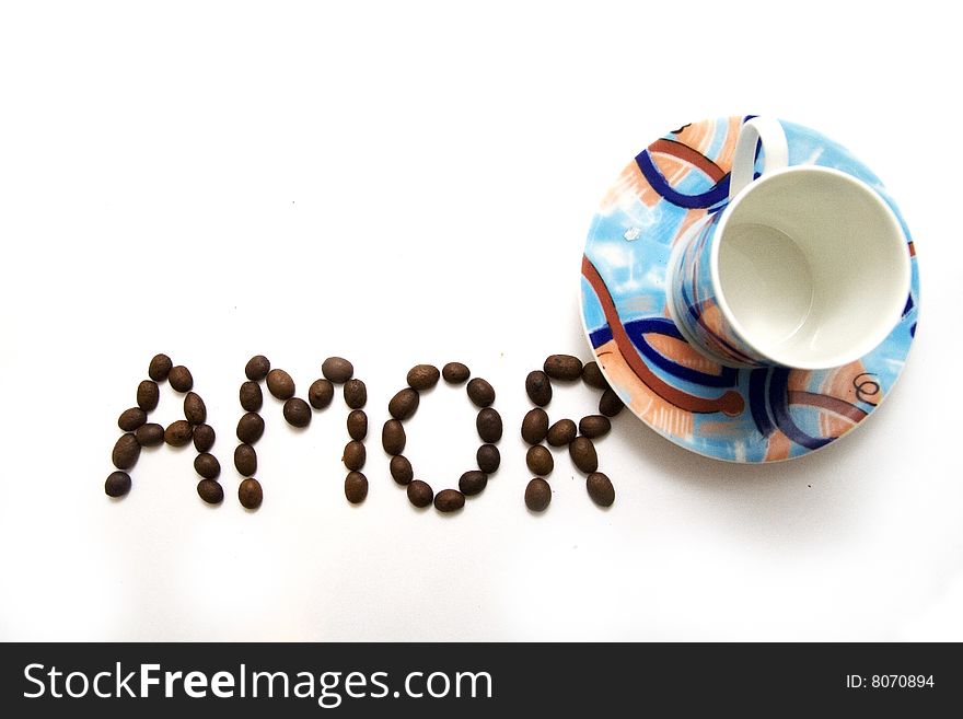 Inscription AMOR with coffee beans and a coffee cup. Inscription AMOR with coffee beans and a coffee cup