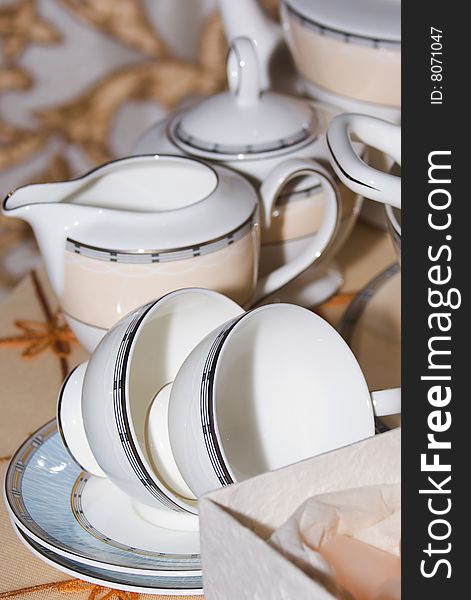 Tea cups on saucers and teapot. Tea cups on saucers and teapot