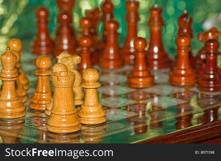 Slanted view  of a chess board during the first stage of the game