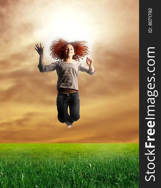 Portrait of a young teen jumping in a grass field