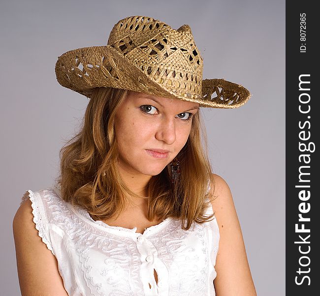 Portrait of young woman in a straw hat. Portrait of young woman in a straw hat