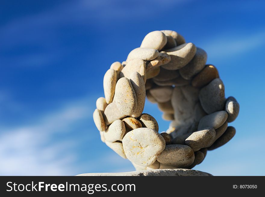 Sphere from a sea pebble against the sky. Sphere from a sea pebble against the sky