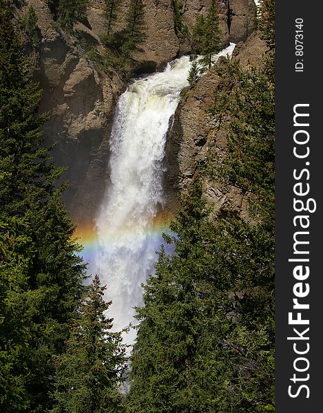 A waterfall cascading through a rainbow. A waterfall cascading through a rainbow.