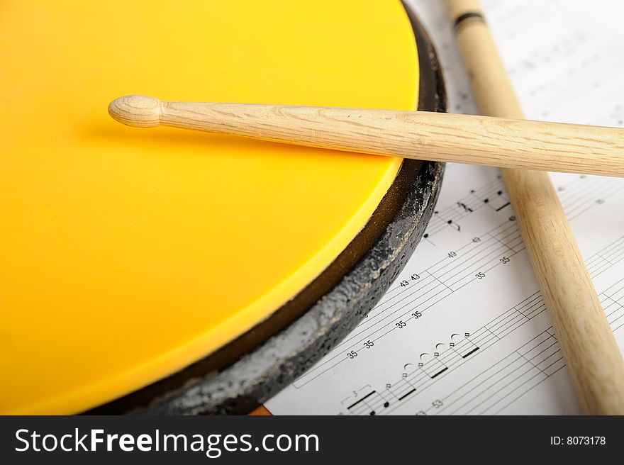 Pair of drumsticks, training pad and note paper