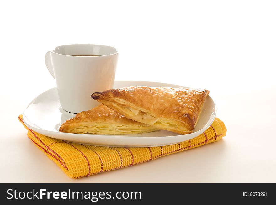 Fresh baked apple turnovers served with coffee.