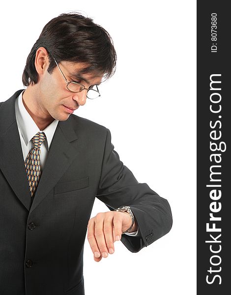 Businessman looks at watch on white