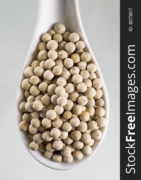 Spoonful of white peppercorns - overhead