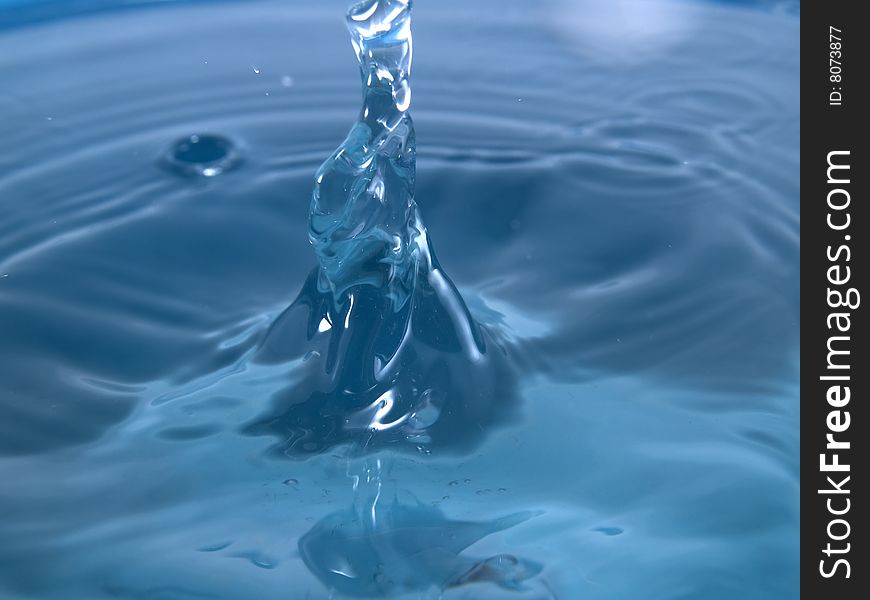 Splash on blue water surface macro horizontal. Splash on blue water surface macro horizontal