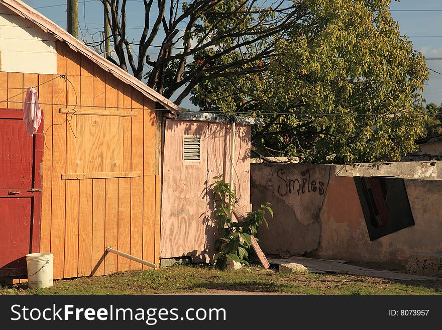 Bright colored  poor  home on tropical island resort with grafitti. Bright colored  poor  home on tropical island resort with grafitti