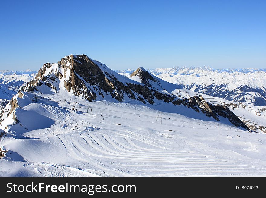 Austria. Mountains. The Alpes.Tops of mountains in a snow and the bright dark blue sky.