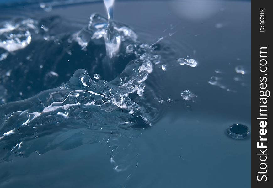 Splash on blue water surface macro horizontal. Splash on blue water surface macro horizontal