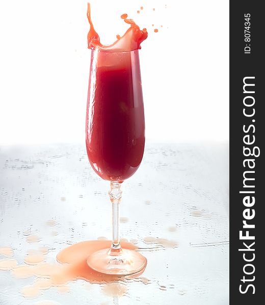 Tomato juice splash in glass white background