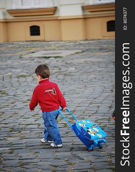 Little boy caring his carry-on. Little boy caring his carry-on