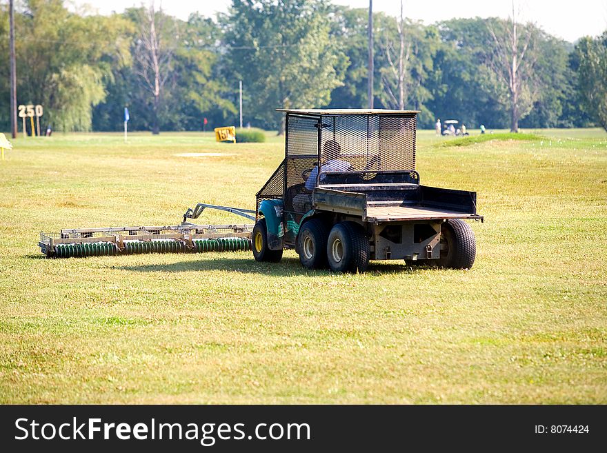 A Golf Ball Collecting Vehicle at the Golf Course. A Golf Ball Collecting Vehicle at the Golf Course