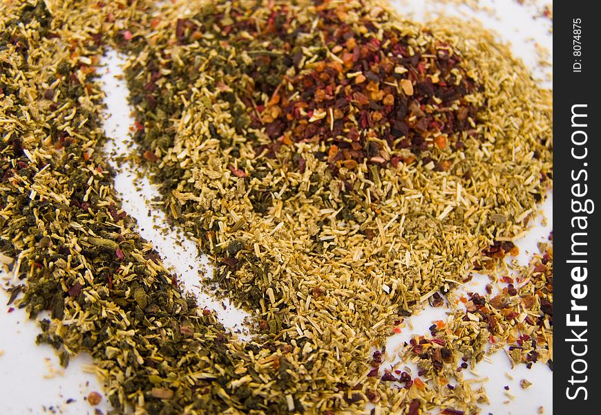 Tea heart shaped of three different types of ground tea leaves (green tea, chamomile tea and hibiscus tea), colorful *suitable for abstract love and Valentine cards and greetings **RAW format available
