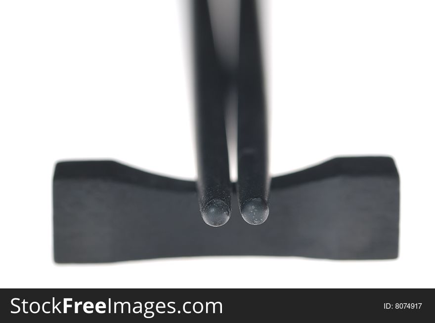 Black chopsticks isolated on the white background. Narrow depth of field. Black chopsticks isolated on the white background. Narrow depth of field.