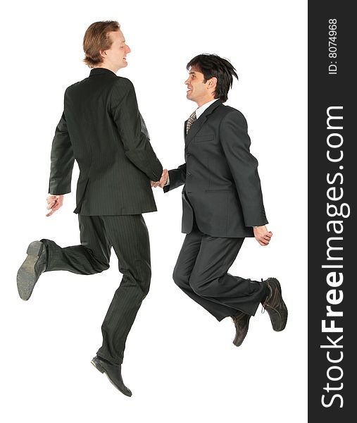 Two businessmen jumping, hand shaking