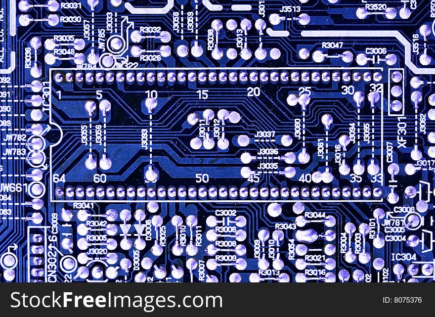 Close-up of microcircuit board. Old an dirty. Texture. Deep blue color.