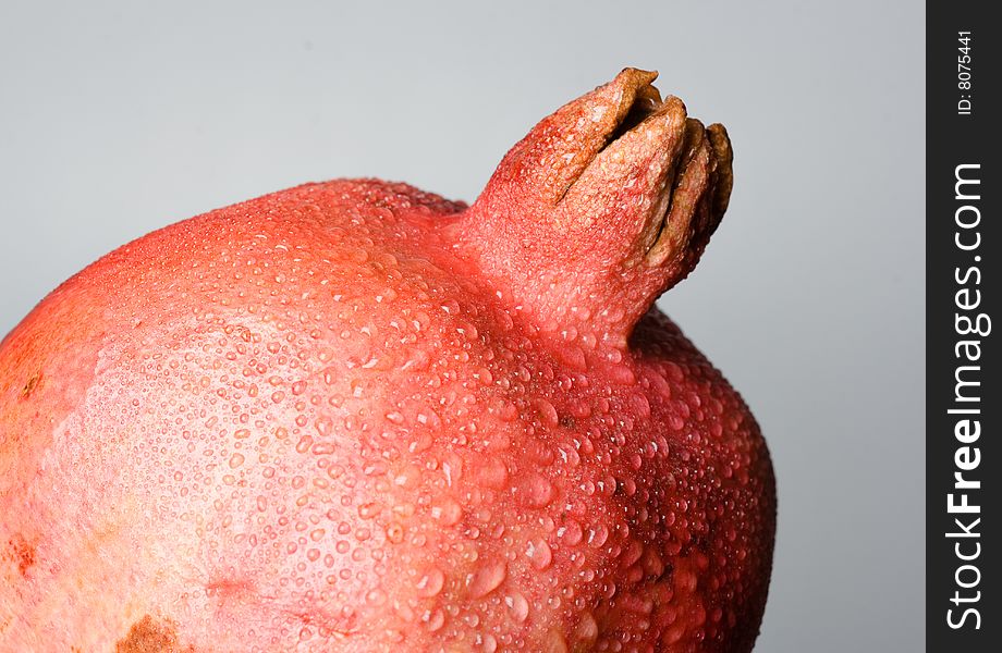 Pomegranate fruit with water drops.