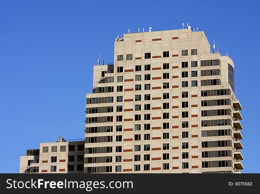 View of modern high rise building comprised of hotel space, stores, and condominiums. View of modern high rise building comprised of hotel space, stores, and condominiums