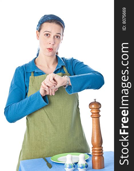A woman in a domestic role looking at her watch and not happy. A woman in a domestic role looking at her watch and not happy.