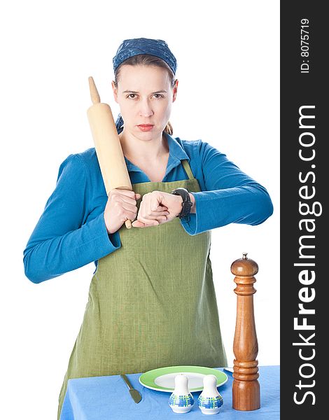 A woman in a domestic role upset and holding a rolling pin. A woman in a domestic role upset and holding a rolling pin.