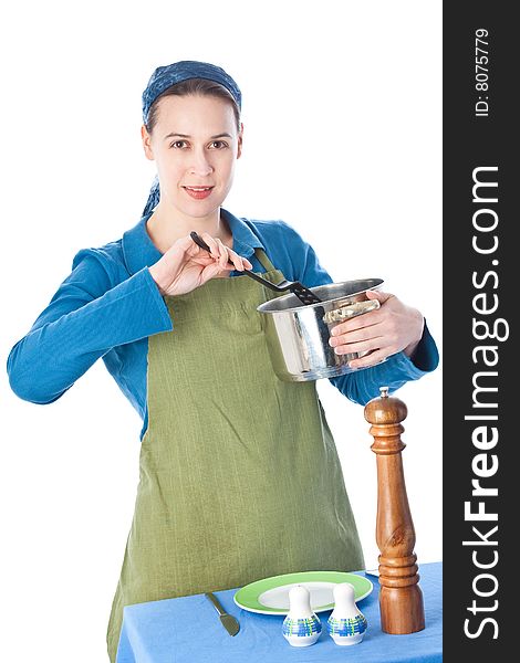 A woman in a domestiuc role serving a meal. A woman in a domestiuc role serving a meal