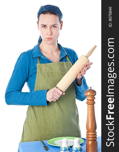 A woman in a domestic role looking angry with a rolling pin. A woman in a domestic role looking angry with a rolling pin.