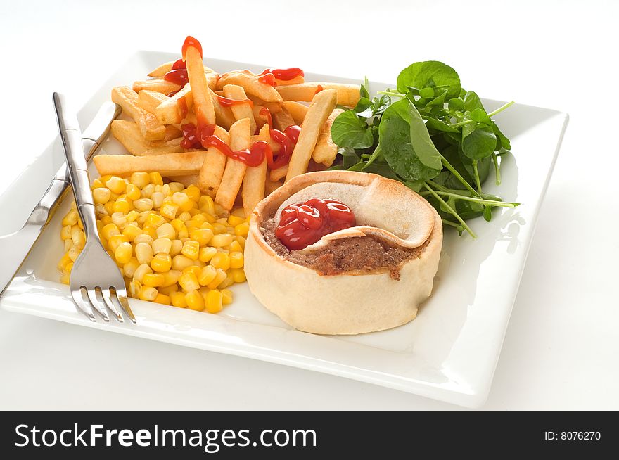 Homemade beef meat pie with fries and vegetables. Homemade beef meat pie with fries and vegetables.