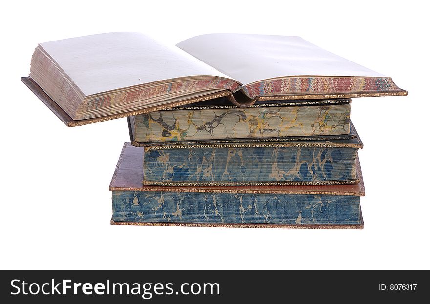 A pile of old leather bound books isolated on a white background