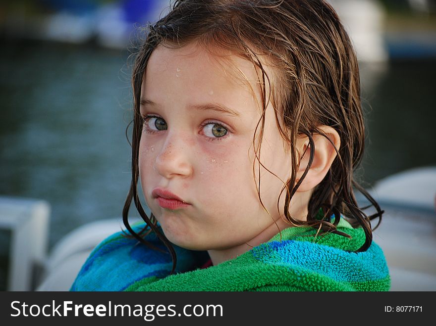 A little girl pouts after a long day of swimming and summer fun. A little girl pouts after a long day of swimming and summer fun