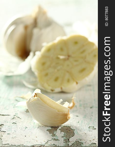 Garlic piece isolated from bulb on wooden background. Garlic piece isolated from bulb on wooden background.