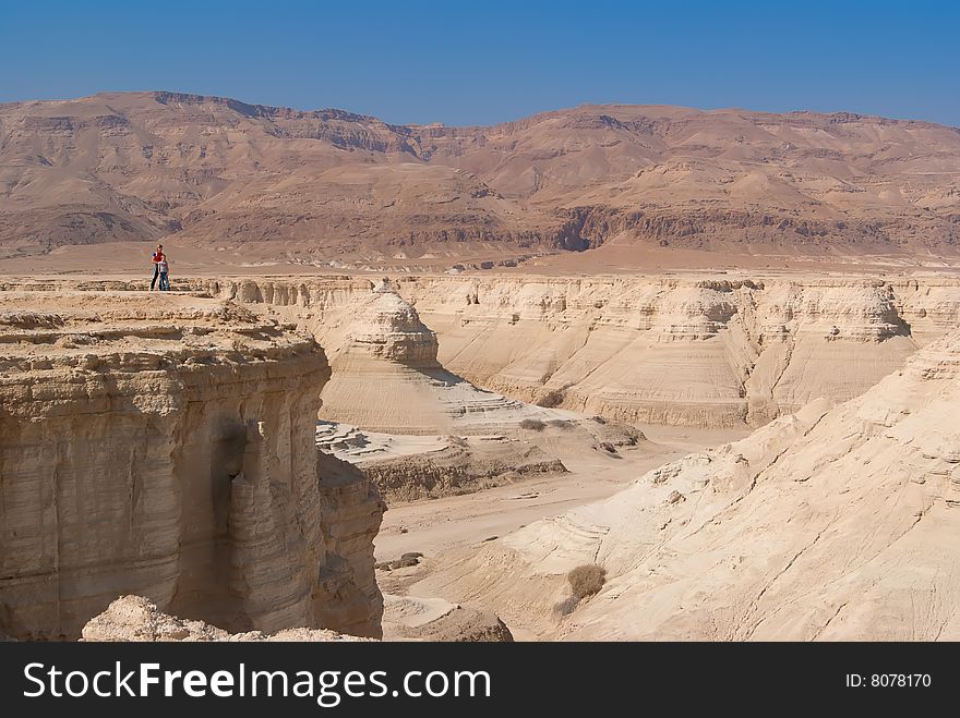 People on Perazim canyon cliff. Judean Desert nature reserve, Israel.