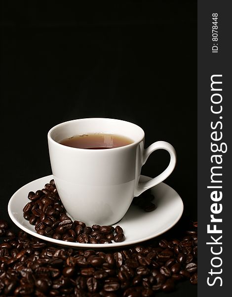 White Coffee cup and coffee beans on white  background with space for text. White Coffee cup and coffee beans on white  background with space for text