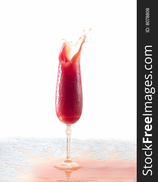 Tomato juice splash in glass white background