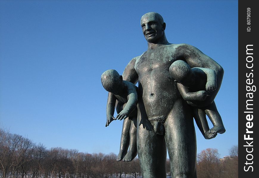 Sculpure of man with kids, Vigeland sculpture park Oslo, Norway.