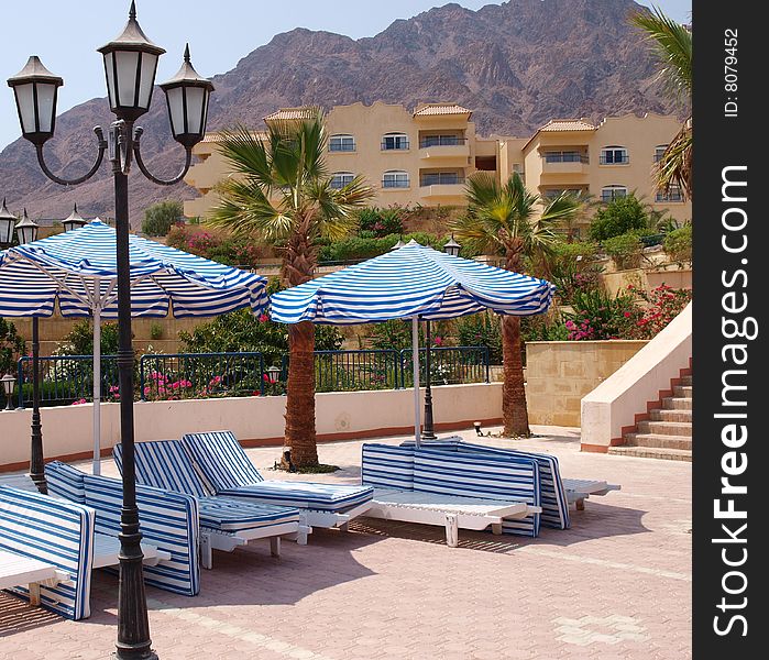 Empty deckchairs on territory of hotel