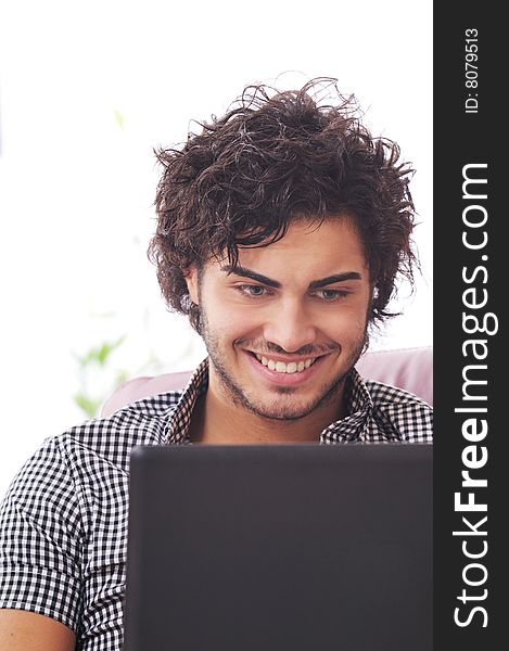 A young man using laptop, happiness and amazement. A young man using laptop, happiness and amazement